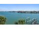 Expansive water view from property, featuring a boat dock, palm trees, and waterfront homes at 9939 1St E St, Treasure Island, FL 33706