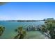 Expansive water view from property, featuring a boat dock, palm trees, and waterfront homes at 9939 1St E St, Treasure Island, FL 33706