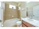 Tiled bathroom with shower over tub and large mirror at 10212 Holland Rd, Riverview, FL 33578