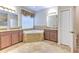 Bathroom showcasing a garden tub, double sinks, tile flooring, and a separate shower at 10212 Holland Rd, Riverview, FL 33578