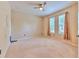 Spacious bedroom with plush carpeting, ceiling fan, and natural light streaming through the windows at 10212 Holland Rd, Riverview, FL 33578