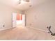Bright, empty bedroom with carpet, a ceiling fan, and an open doorway that leads to the home's foyer at 10212 Holland Rd, Riverview, FL 33578
