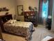 Cozy bedroom featuring a wooden bookcase, floral bedding, and soft neutral tones at 10212 Holland Rd, Riverview, FL 33578
