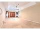Spacious carpeted main bedroom with a tray ceiling, ceiling fan, and two large windows for natural light at 10212 Holland Rd, Riverview, FL 33578
