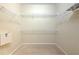 A large walk-in closet with neutral walls and carpet, equipped with wire shelving for organized storage at 10212 Holland Rd, Riverview, FL 33578