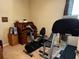 Exercise room with treadmill, exercise bike, and wooden desk at 10212 Holland Rd, Riverview, FL 33578