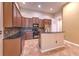 Kitchen area with granite countertops, tiled backsplash, and wooden cabinets at 10212 Holland Rd, Riverview, FL 33578