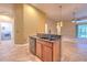 Modern kitchen island features granite countertops, a sink, and updated appliances at 10212 Holland Rd, Riverview, FL 33578