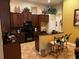 Well-appointed kitchen featuring dark cabinetry, a breakfast bar, and tiled flooring at 10212 Holland Rd, Riverview, FL 33578