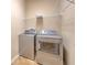 Laundry room featuring a washer and dryer, tile floor, and shelving for storage at 10212 Holland Rd, Riverview, FL 33578