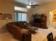 Comfortable living area with a large sectional sofa, entertainment center, and lots of natural light at 10212 Holland Rd, Riverview, FL 33578