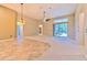 Bright living room with tile and carpet flooring, high ceilings, and a sliding glass door to the outdoors at 10212 Holland Rd, Riverview, FL 33578