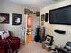 Fun living room featuring guitars, movie memorabilia, and a large TV at 10212 Holland Rd, Riverview, FL 33578