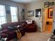 Eclectic living room featuring guitars, movie memorabilia, and comfortable seating at 10212 Holland Rd, Riverview, FL 33578