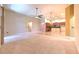 Spacious open-concept living space with tile flooring, kitchen view, and neutral tones at 10212 Holland Rd, Riverview, FL 33578