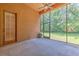 A screened patio offers an outdoor view with access to the backyard and natural light through a screened wall at 10212 Holland Rd, Riverview, FL 33578