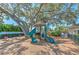 Community playground featuring a slide, covered play structure, and swings at 10212 Holland Rd, Riverview, FL 33578