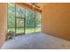 View of the screened patio with a ceiling fan and access to the backyard at 10212 Holland Rd, Riverview, FL 33578