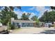Charming single-story home with a neutral exterior, set against a backdrop of lush trees and a bright, cloudy sky at 1114 27Th Se St # A, Ruskin, FL 33570