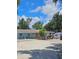 A single-story home with a neutral exterior surrounded by lush greenery, set on a gravel lot under a bright sky at 1114 27Th Se St # A, Ruskin, FL 33570
