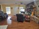 Spacious living room with a brick fireplace, hardwood floors, and a comfortable seating area near bright windows at 1114 27Th Se St # A, Ruskin, FL 33570