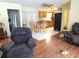 Inviting living room with hardwood floors, blending into a dining area with a wooden table and chairs at 1114 27Th Se St # A, Ruskin, FL 33570