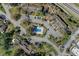 Aerial view of the community featuring the pool, clubhouse, and surrounding buildings with parking areas at 1200 Tarpon Woods Blvd # M8, Palm Harbor, FL 34685
