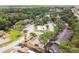 Aerial view of the community featuring a central pool and spa surrounded by lush landscaping and mature trees at 1200 Tarpon Woods Blvd # M8, Palm Harbor, FL 34685