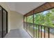 Screened balcony offering a serene view of lush trees and a tranquil lake, ideal for outdoor relaxation at 1200 Tarpon Woods Blvd # M8, Palm Harbor, FL 34685