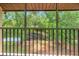 This screened balcony features a peaceful view of a tranquil lake surrounded by beautiful mature trees at 1200 Tarpon Woods Blvd # M8, Palm Harbor, FL 34685