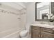 Updated bathroom featuring a shower-tub combo with decorative tiling and a stylish vanity sink at 1200 Tarpon Woods Blvd # M8, Palm Harbor, FL 34685