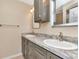 Bathroom featuring double sink vanity with gray cabinets and granite counters at 1200 Tarpon Woods Blvd # M8, Palm Harbor, FL 34685