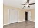 Bedroom featuring neutral walls, closet, and access to other rooms at 1200 Tarpon Woods Blvd # M8, Palm Harbor, FL 34685