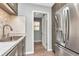 View of stainless steel refrigerator and sink in kitchen at 1200 Tarpon Woods Blvd # M8, Palm Harbor, FL 34685