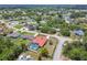 Aerial view of a home with an enclosed pool in a quiet residential neighborhood near a pond at 12371 Talpa St, Spring Hill, FL 34608