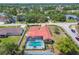 Overhead view of the property including a large, screened pool with spa and fenced in yard at 12371 Talpa St, Spring Hill, FL 34608