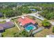 Aerial view of a house with a screened pool and white privacy fence in a wooded neighborhood at 12371 Talpa St, Spring Hill, FL 34608