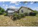 Backyard featuring plants and grass, the home's exterior and an enclosed swimming pool at 12371 Talpa St, Spring Hill, FL 34608