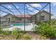 Backyard featuring a swimming pool surrounded by green grass and plants at 12371 Talpa St, Spring Hill, FL 34608