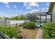 Backyard featuring green grass, plants and an enclosed swimming pool and backyard at 12371 Talpa St, Spring Hill, FL 34608