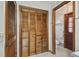 Bathroom featuring tiled floors, a wood closet, and access to the toilet at 12371 Talpa St, Spring Hill, FL 34608