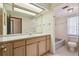 Bathroom featuring a vanity with a large mirror and a shower-tub combo at 12371 Talpa St, Spring Hill, FL 34608