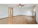 Open-concept bedroom features laminate floors, neutral paint tones, and convenient access to the hallway at 12371 Talpa St, Spring Hill, FL 34608