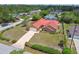 Well-maintained single-story home featuring a red roof, attached garage, and mature landscaping at 12371 Talpa St, Spring Hill, FL 34608