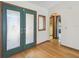 Bright foyer featuring a stained glass front door and light hardwood floors at 12371 Talpa St, Spring Hill, FL 34608