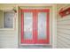 The brick exterior features a decorative red double-door entrance with adjacent window at 12371 Talpa St, Spring Hill, FL 34608