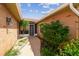 Enclosed courtyard entrance of a home featuring brick walls, a paved walkway and beautiful garden at 12371 Talpa St, Spring Hill, FL 34608