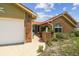 Single-story home featuring brick accents, light yellow siding, and a walkway at 12371 Talpa St, Spring Hill, FL 34608