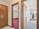 Hallway view shows doorways leading to bedrooms with neutral walls and varied carpeting at 12371 Talpa St, Spring Hill, FL 34608