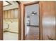 Hallway view shows doorways leading to laundry room, and bedroom with ceiling fan at 12371 Talpa St, Spring Hill, FL 34608